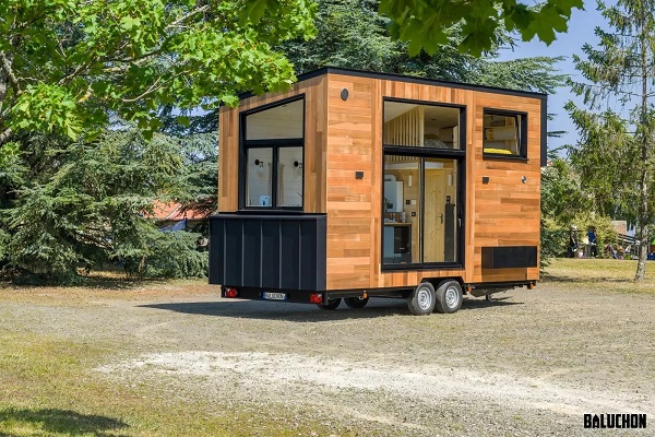 Generous glazing floods compact tiny house interior with daylight