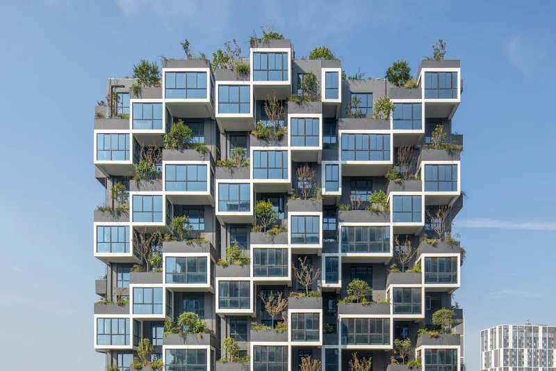 Resedetial Towers that,are Covered in thousands of Trees and Plants